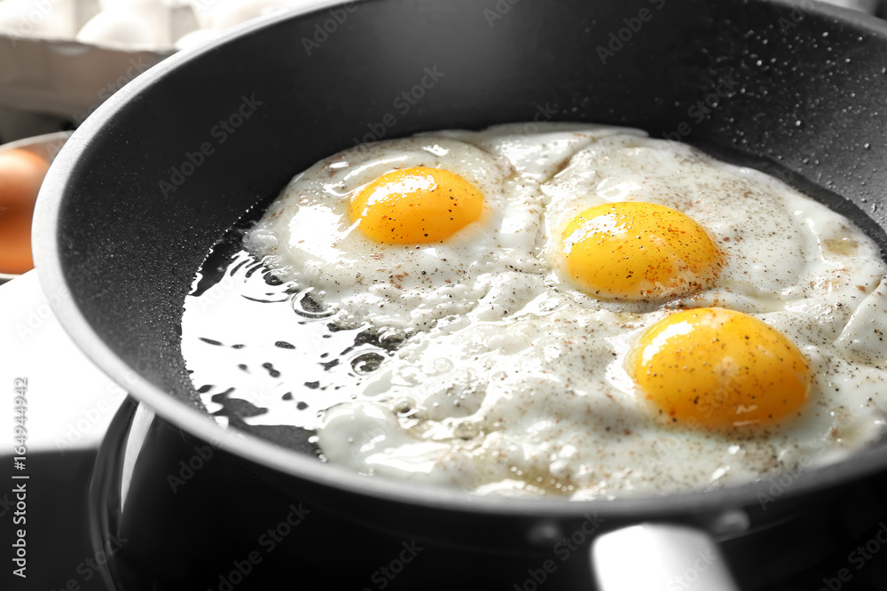 Delicious over easy eggs in pan, closeup Delicious over easy eggs in pan, closeup
