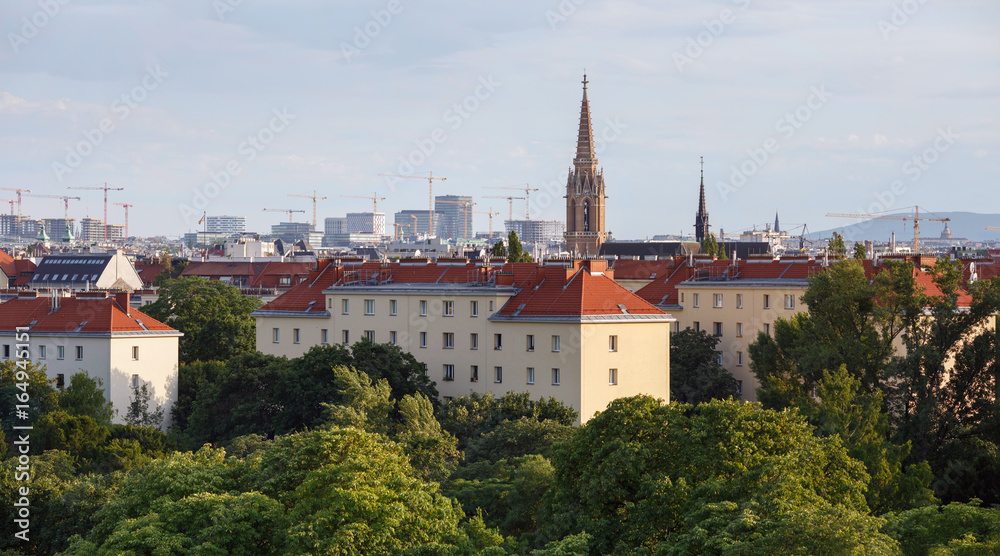 Aerial view of the third municipal district of Vienna with the St.Othmar Church in the center and a lot of construction cranes on the horizon. Vienna, Austria.