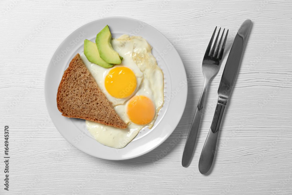 Delicious breakfast with over easy eggs on wooden background Delicious breakfast with over easy eggs on wooden background