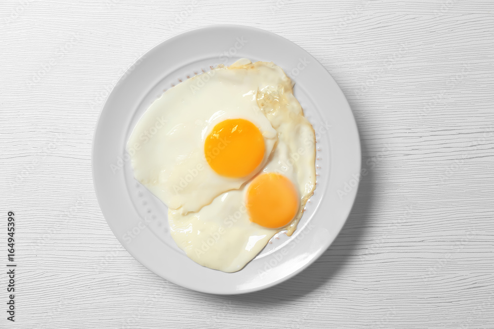 Delicious breakfast with over easy eggs on wooden background Delicious breakfast with over easy eggs on wooden background
