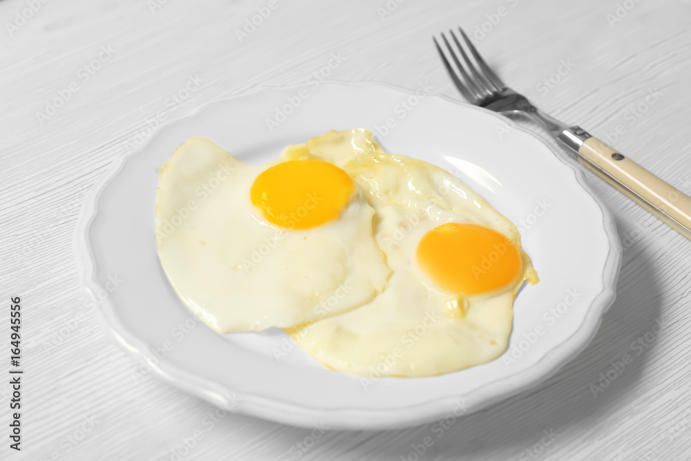 Delicious breakfast with over easy eggs on wooden background Delicious breakfast with over easy eggs on wooden background