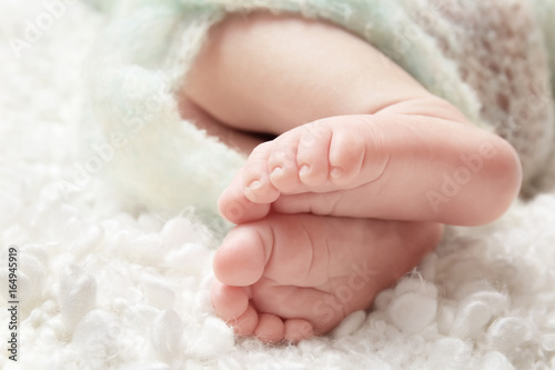 Baby feet on soft blanket, closeup