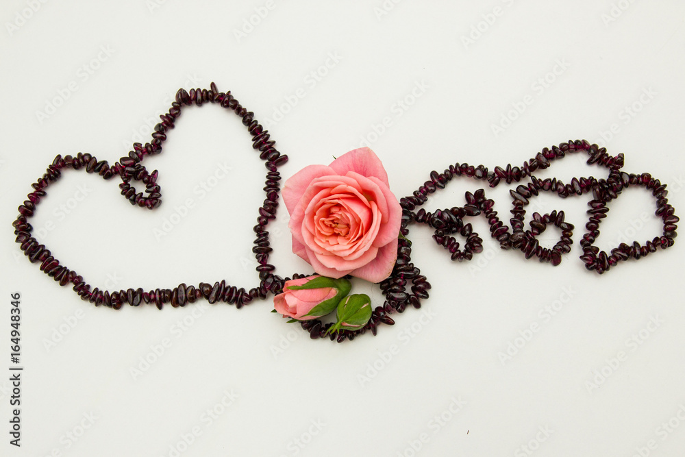 Garnet thread heart with rose on the white background Garnet thread heart with rose on the white background