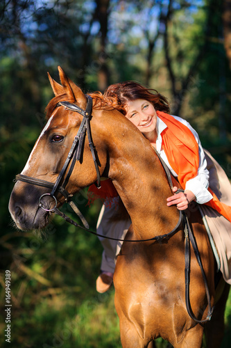 woman rides a horse in the beautiful park