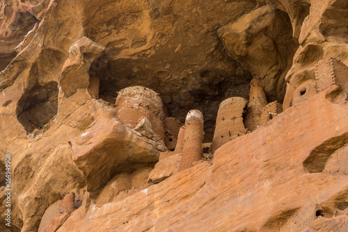 Abandoned cliff dwellings on the Bandiagara escarpment above Piri village, Dogon Country, Mali  photo