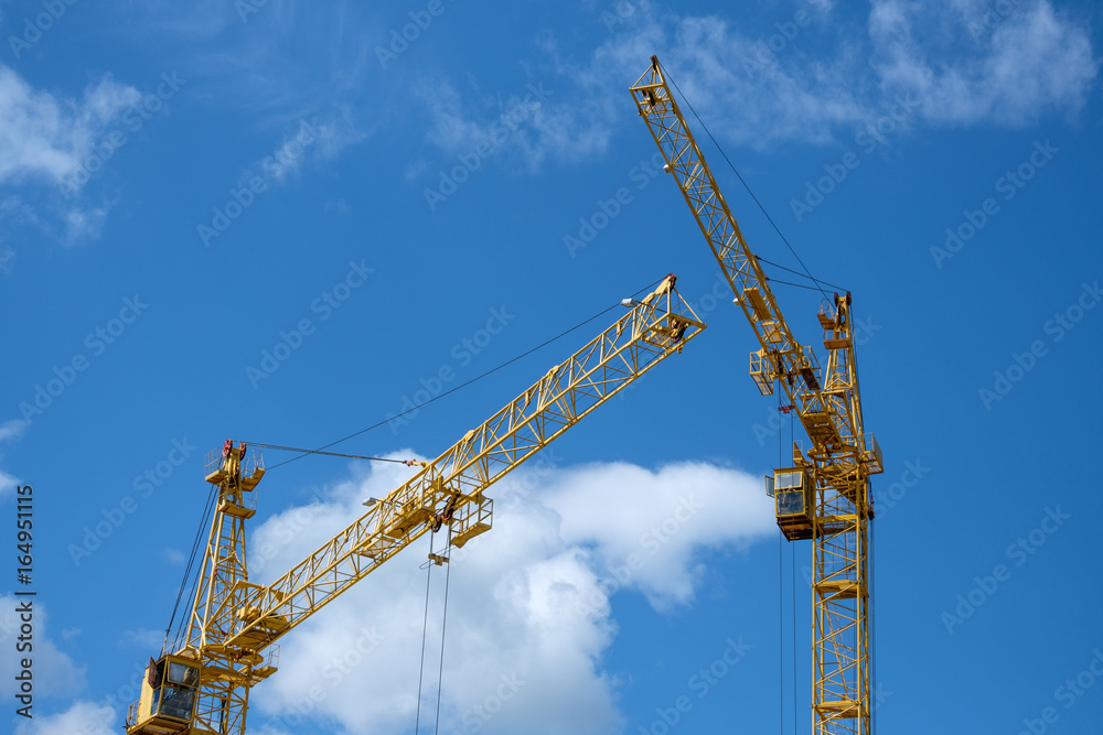 Two tower crane on sky background Two tower crane on sky background