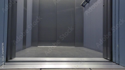 Elevator door opening and closing in a hallway