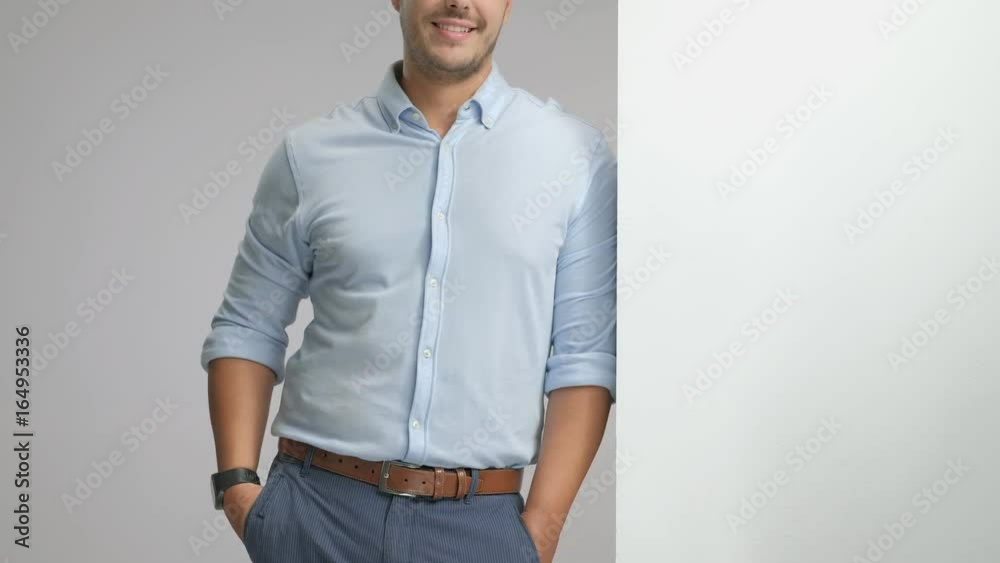Elegant guy leaning against wall and making thumb up gesture Elegant guy leaning against wall and making thumb up gesture