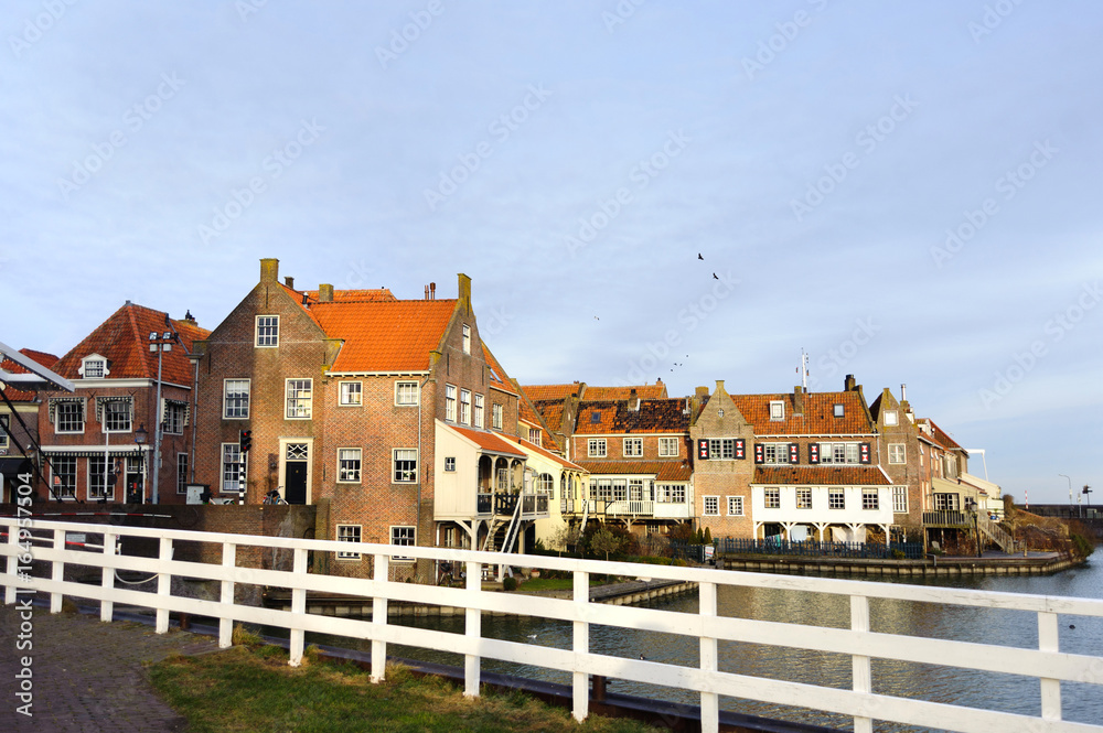 View from the bridge in Enkhuizen (city in Netherlands) traditional old brick buildings with tile roofs