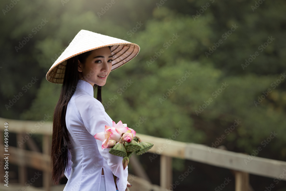 Naklejka premium Medium long shot beautiful woman wearing Ao Dai Vietnam traditional dress