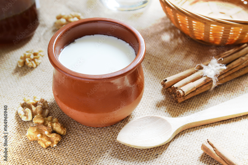 Natural curd with cinnamon and some nuts served on a burlap fabric. Rustic breakfast. Natural curd with cinnamon and some nuts served on a burlap fabric. Rustic breakfast.