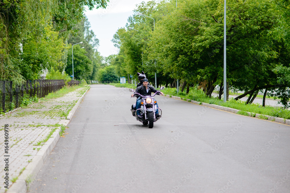 A beautiful couple in love is riding a motorbike. A beautiful couple in love is riding a motorbike.