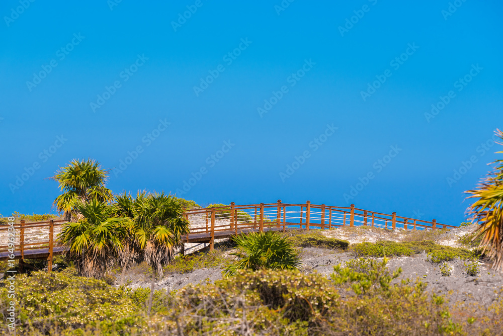 The bridge to the sandy beach Playa Paradise of the island of Cayo Largo, Cuba. Copy space for text. The bridge to the sandy beach Playa Paradise of the island of Cayo Largo, Cuba. Copy space for text.