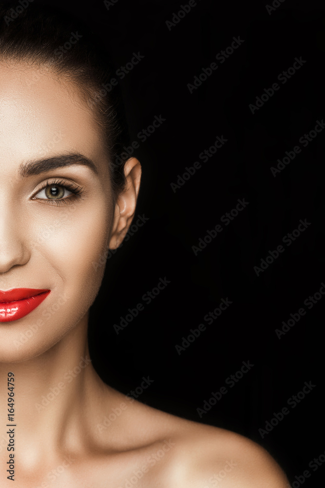 halved view of attractive woman with red lips looking at camera, isolated on black halved view of attractive woman with red lips looking at camera, isolated on black