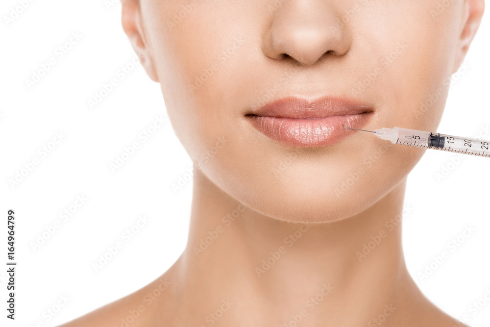 cropped view of beautiful woman making beauty injection for lips, isolated on white