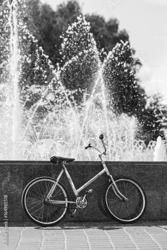 Bicycle near the fountain, black and white frame
