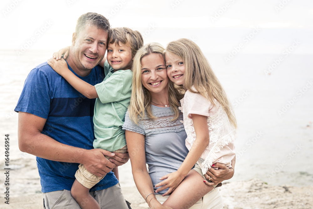 Beautiful happy family on the beach