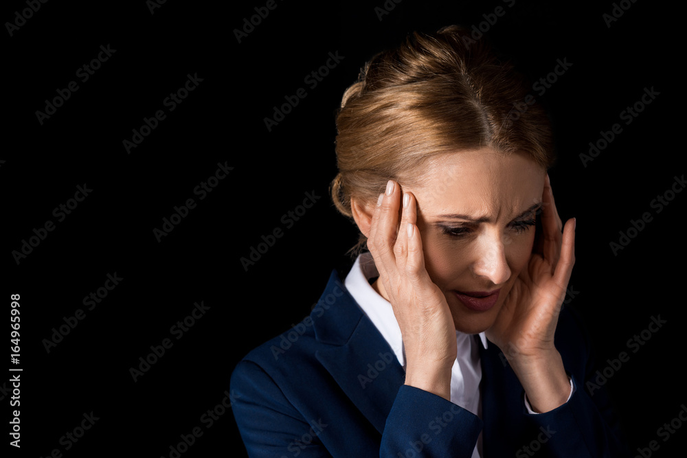 tired middle aged business woman with headache holding hands on temples isolated on black tired middle aged business woman with headache holding hands on temples isolated on black