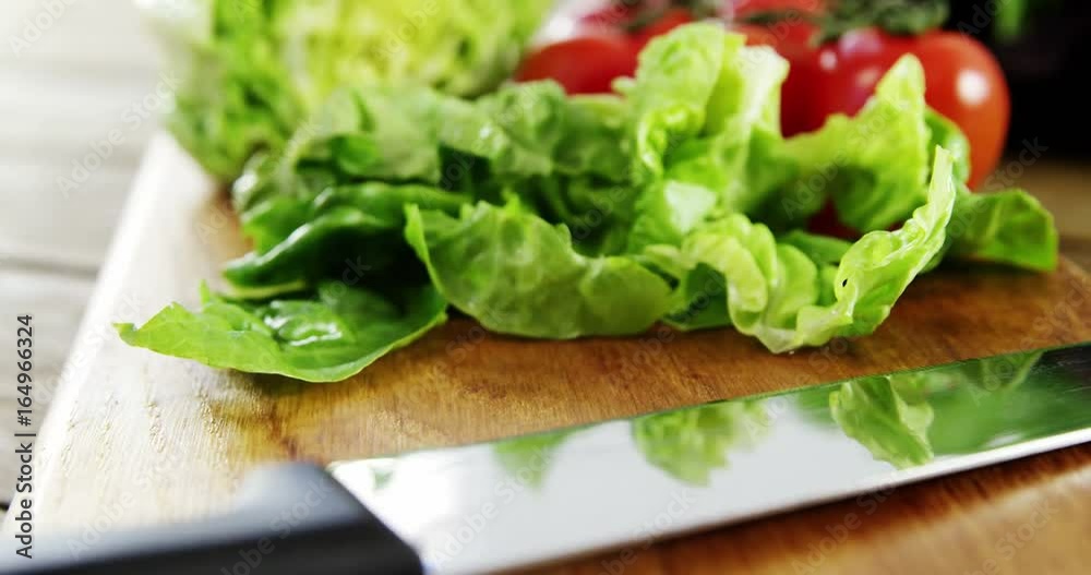 Vegetables and kitchen knife on wooden table Vegetables and kitchen knife on wooden table