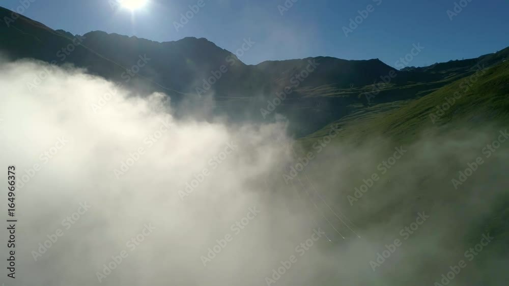 Aerial 4K - Passo dello Stelvio (IT) - Sorvolo fra le nubi all'alba Aerial 4K - Passo dello Stelvio (IT) - Sorvolo fra le nubi all'alba