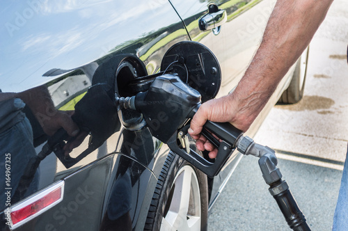 A gas station attendant pumping gas.