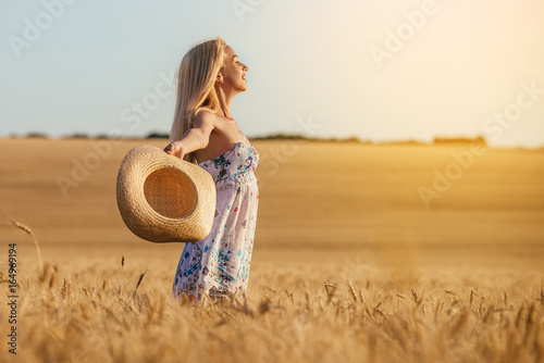 Happy Young woman in a wheat field