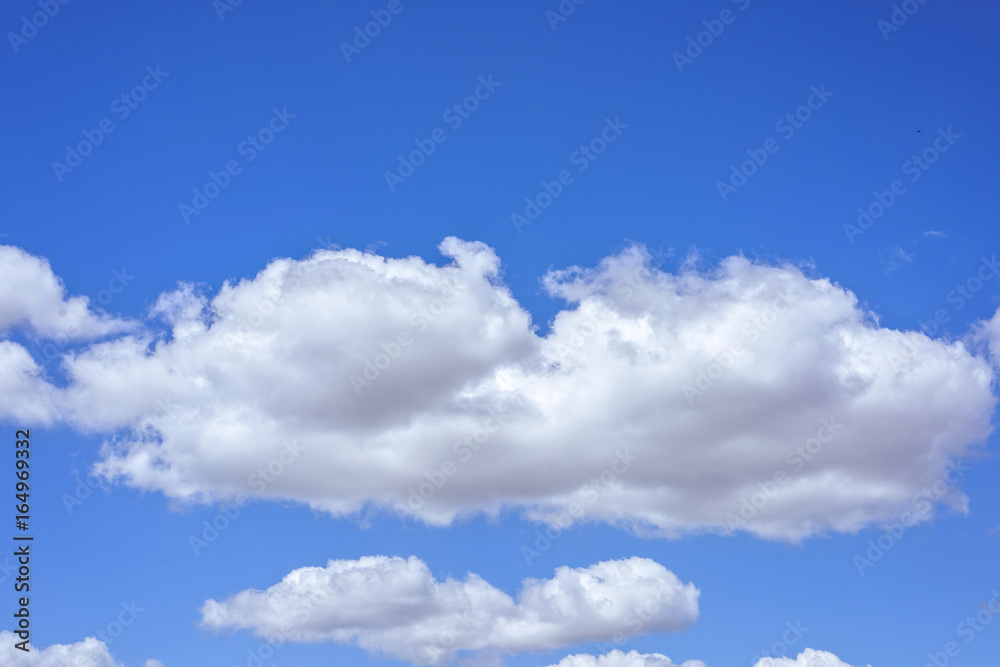 Beautiful big white clouds over blue sky, sunny summer day, close up Beautiful big white clouds over blue sky, sunny summer day, close up