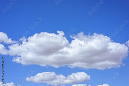 Beautiful big white clouds over blue sky, sunny summer day, close up © frimufilms
