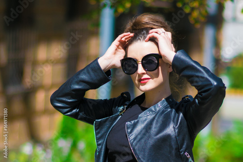 portrait of elegant woman in black dress walking in city © forget_me_not_18