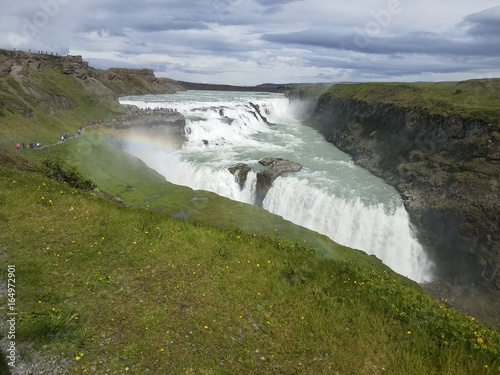 Icelandic waterfall with green surrounding fields