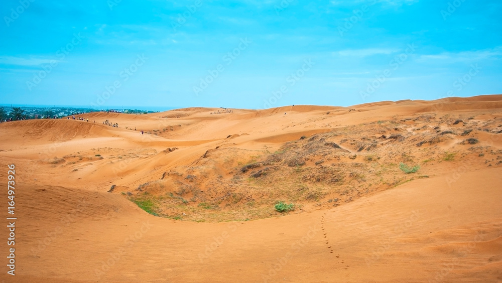 Popular desert area known for red-hued sand dunes & activities such as sand sledding in Phan Thiet, Vietnam. Popular desert area known for red-hued sand dunes & activities such as sand sledding in Phan Thiet, Vietnam.