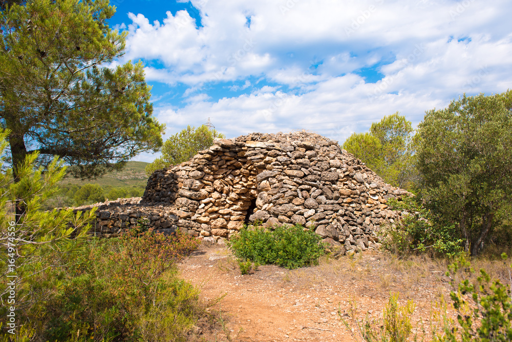 Ruin, dry stone building, 11-15th century, piedra seca, Mont-roig del Camp, Tarragona, Catalunya, Spain. Copy space for text. Ruin, dry stone building, 11-15th century, piedra seca, Mont-roig del Camp, Tarragona, Catalunya, Spain. Copy space for text.