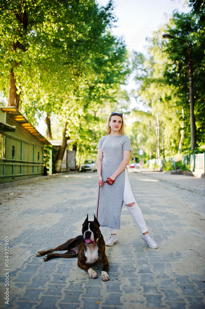 Girl with dog pit bull terrier on a walk.