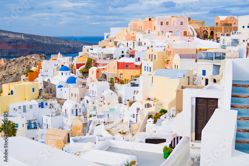 Oia town on Santorini island, Greece. Traditional and famous white and rose houses at sunny day