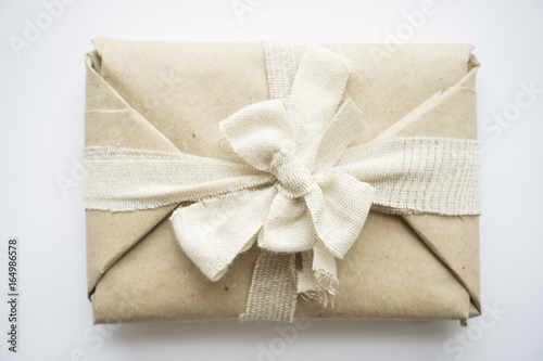 The package with eco vintage paper and linen tape and bow for a gift © elinque