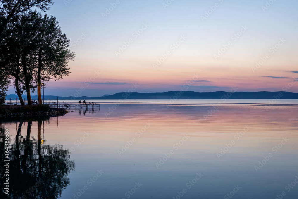 fishermen waiting at sunset at Balaton lake in summer