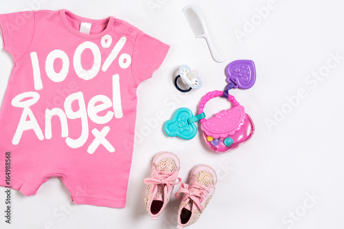 Baby clothes and accessories on white background. Top view