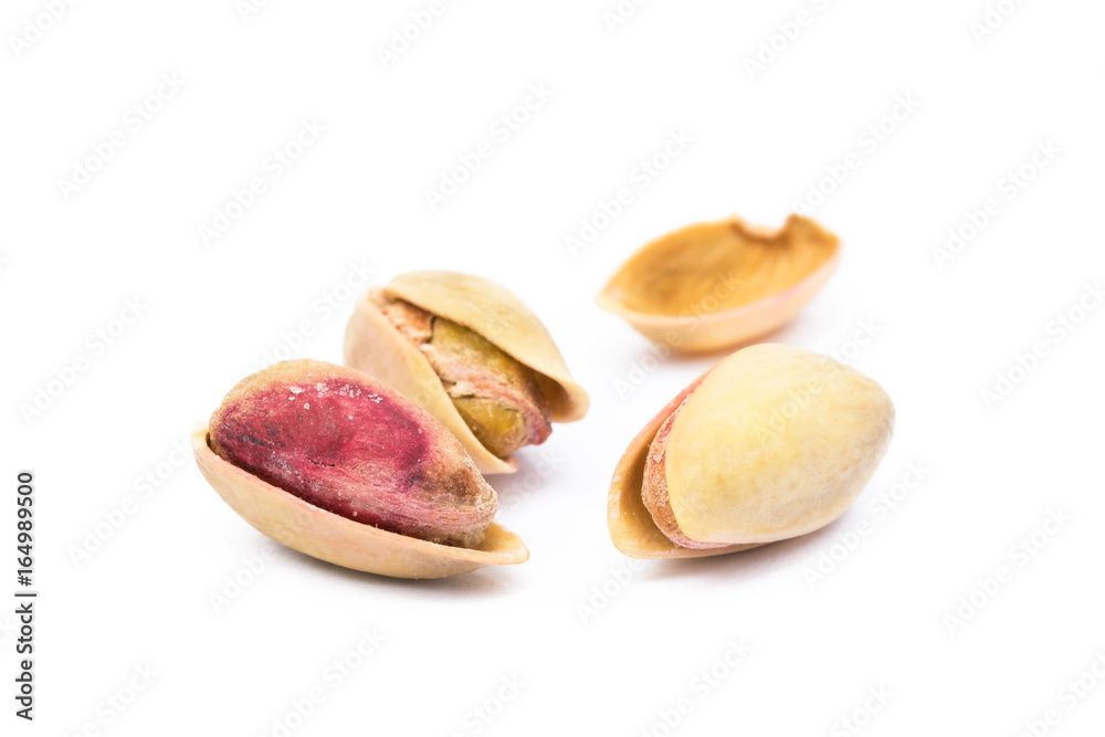 Pile of roasted pistachios isolated on white background Pile of roasted pistachios isolated on white background
