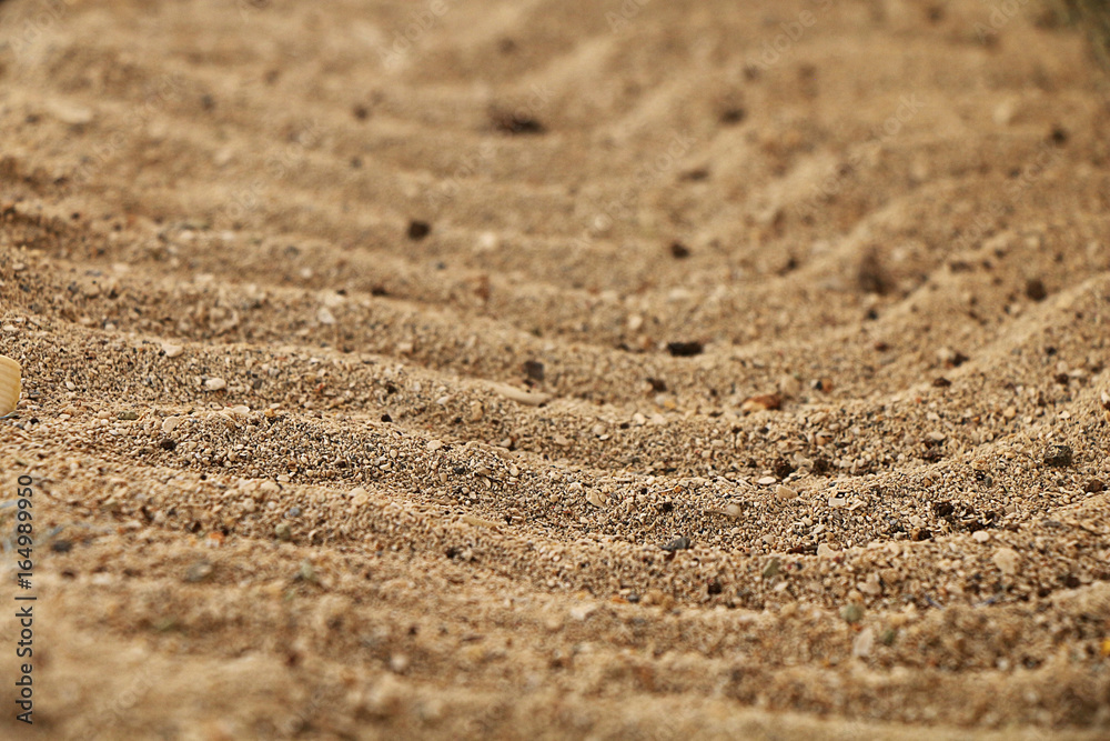 Texture made in the form of small waves on the yellow sea sand Texture made in the form of small waves on the yellow sea sand