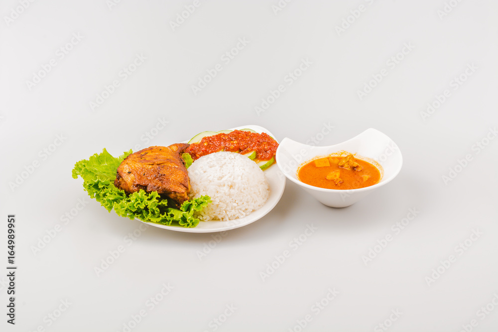 Isolated Ayam goreng penyet, fried chicken ala Indonesia, Indonesian food with condiments