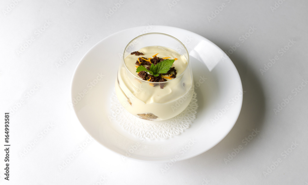 Dessert tiramisu with mint in a transparent glass Dessert tiramisu with mint in a transparent glass