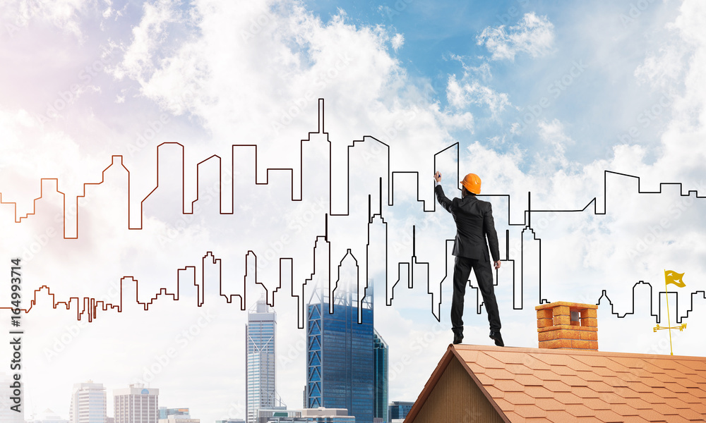 Man architect draw silhouette of modern city on blue sky. Mixed media Man architect draw silhouette of modern city on blue sky. Mixed media