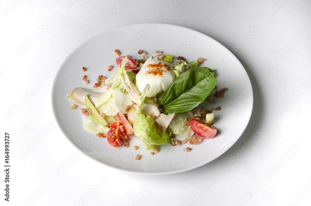 Mix salad with egg poached and chicken on a white plate Mix salad with egg poached and chicken on a white plate