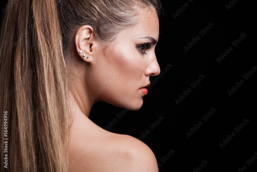 young blonde woman with long hair in ponytail profile studio young blonde woman with long hair in ponytail profile studio