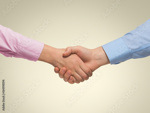 Tug-of-war concept between man and woman on yellow background