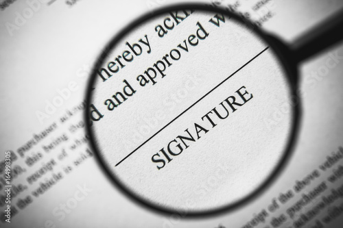 Wallpaper Mural Magnifying glass enlarging signature word on business document. Torontodigital.ca
