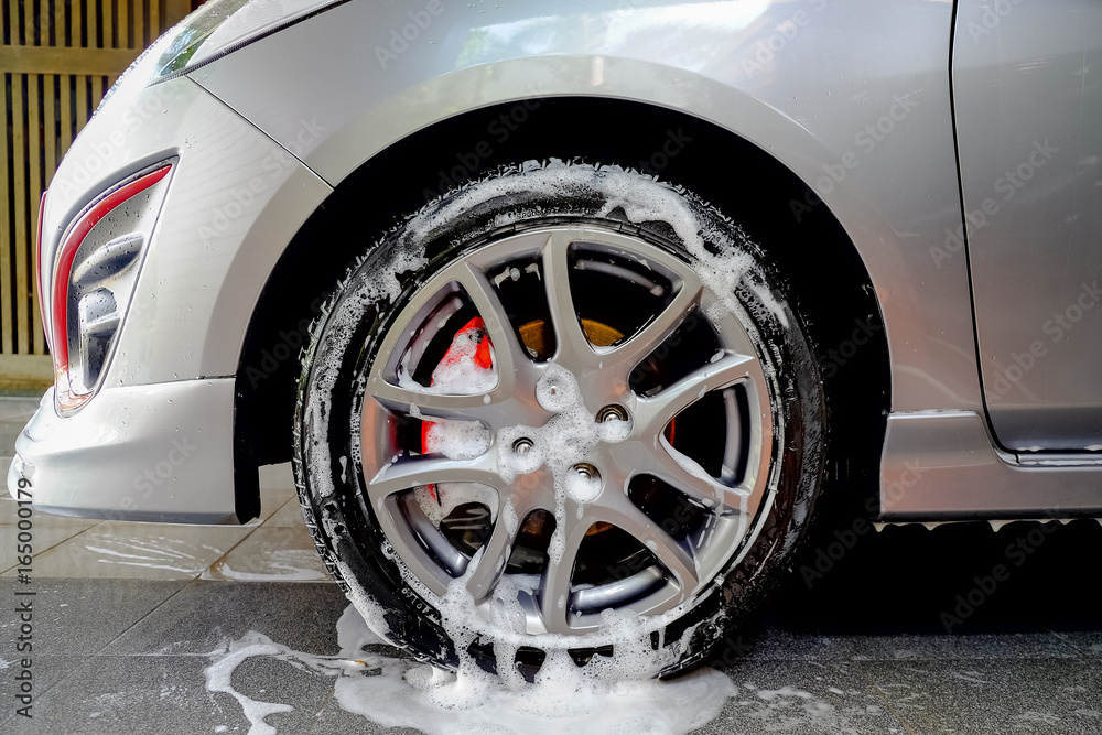 foam washing car wheel