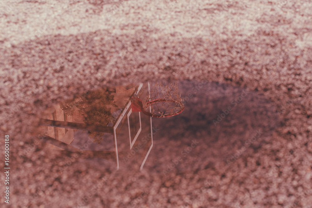 Reflection of basketball hoop in the puddle Reflection of basketball hoop in the puddle