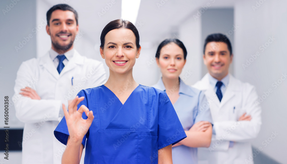group of medics at hospital showing ok hand sign group of medics at hospital showing ok hand sign
