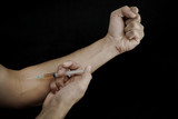 hands making syringe injection of heroin
